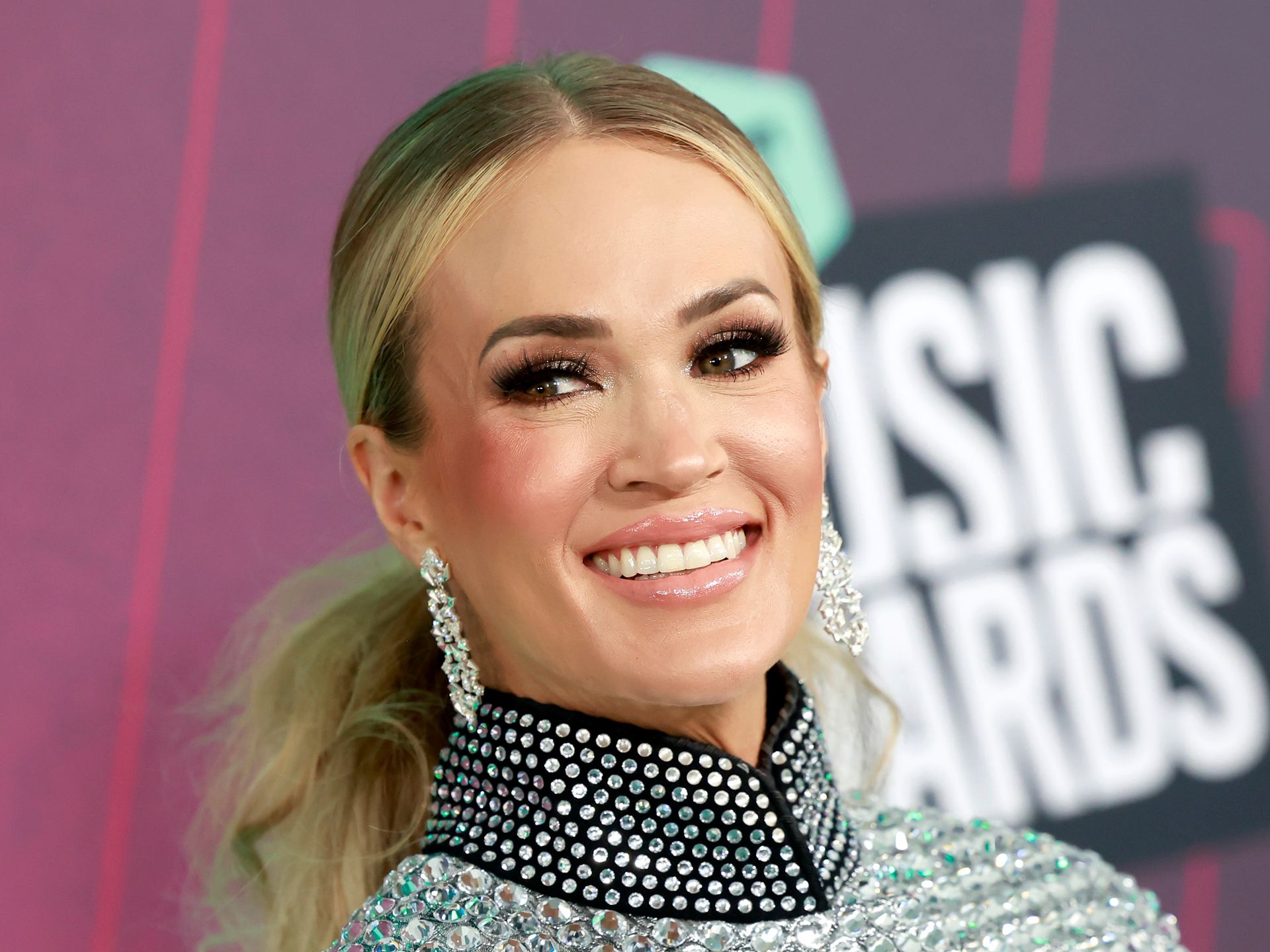 Carrie Underwood's ultra-toned legs steal the show in a metallic romper