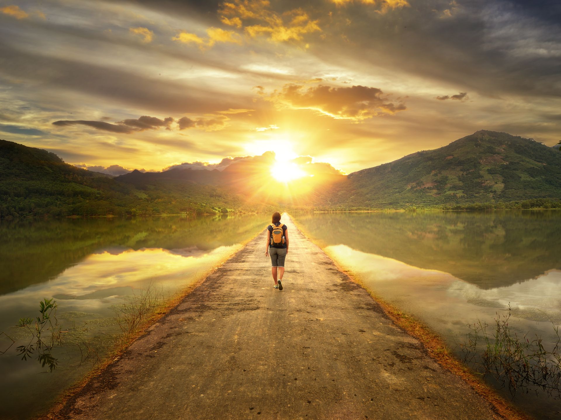 Woman hiking through mountain trail on a sunny day – Jacob Lund