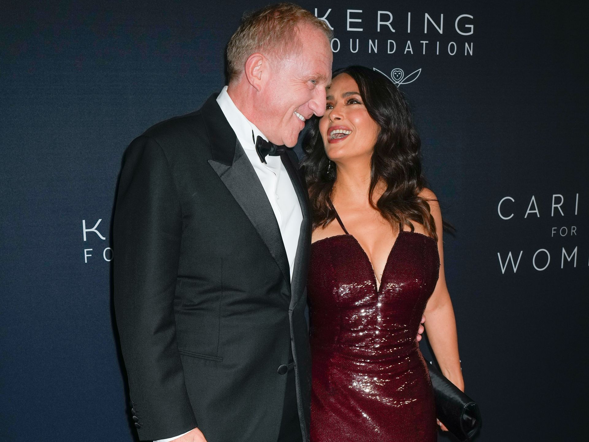 Salma Hayek rocks plunging sequin dress - and her husband can't keep his  hands off her