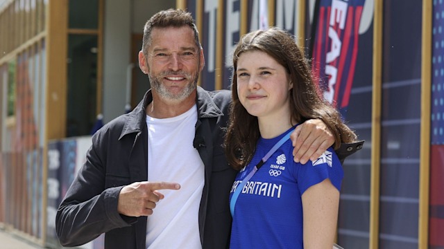 Older man with arm around younger woman