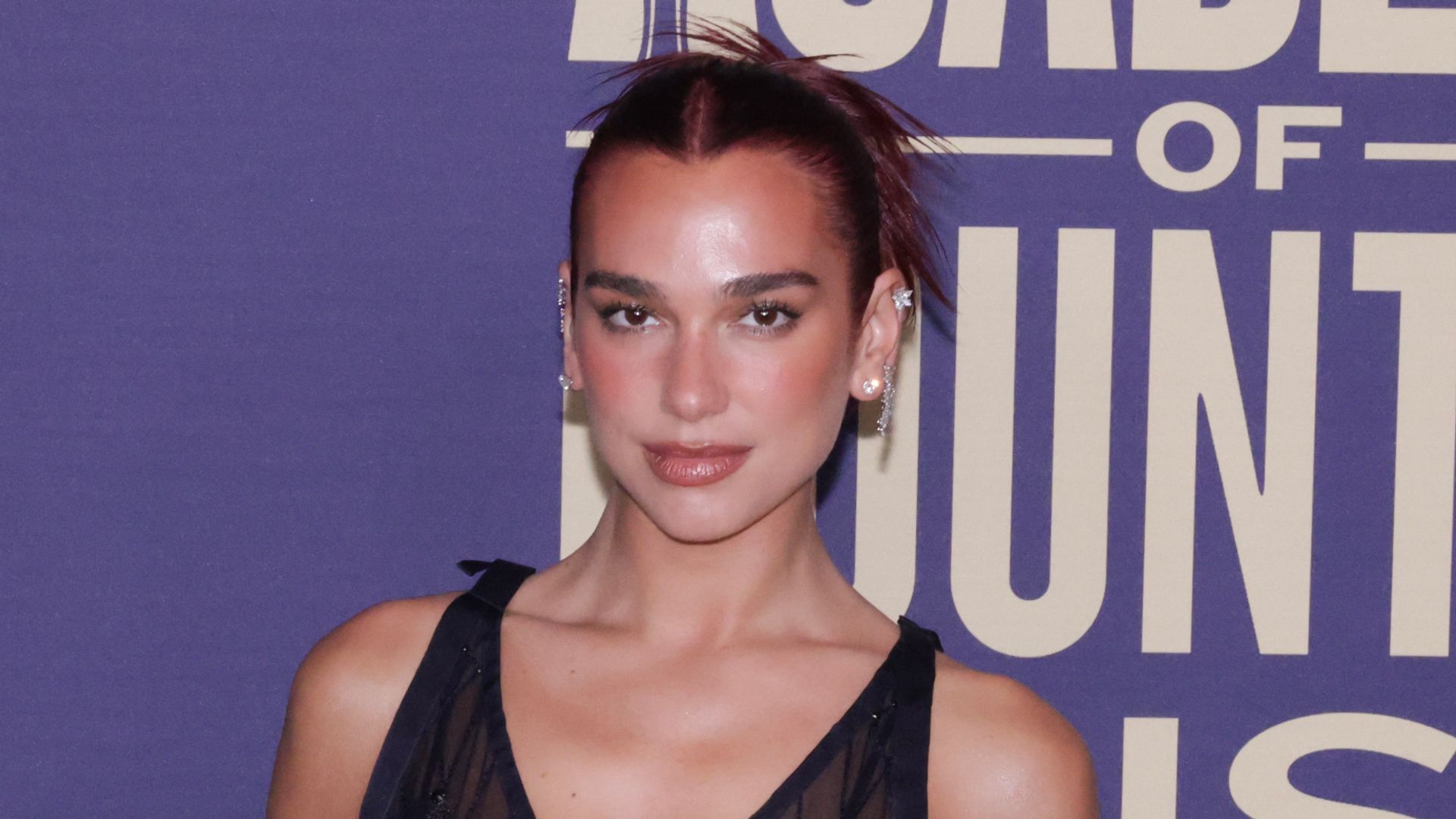 Dua Lipa exposes incredible physique in see-through dress for surprise ACM Awards performance