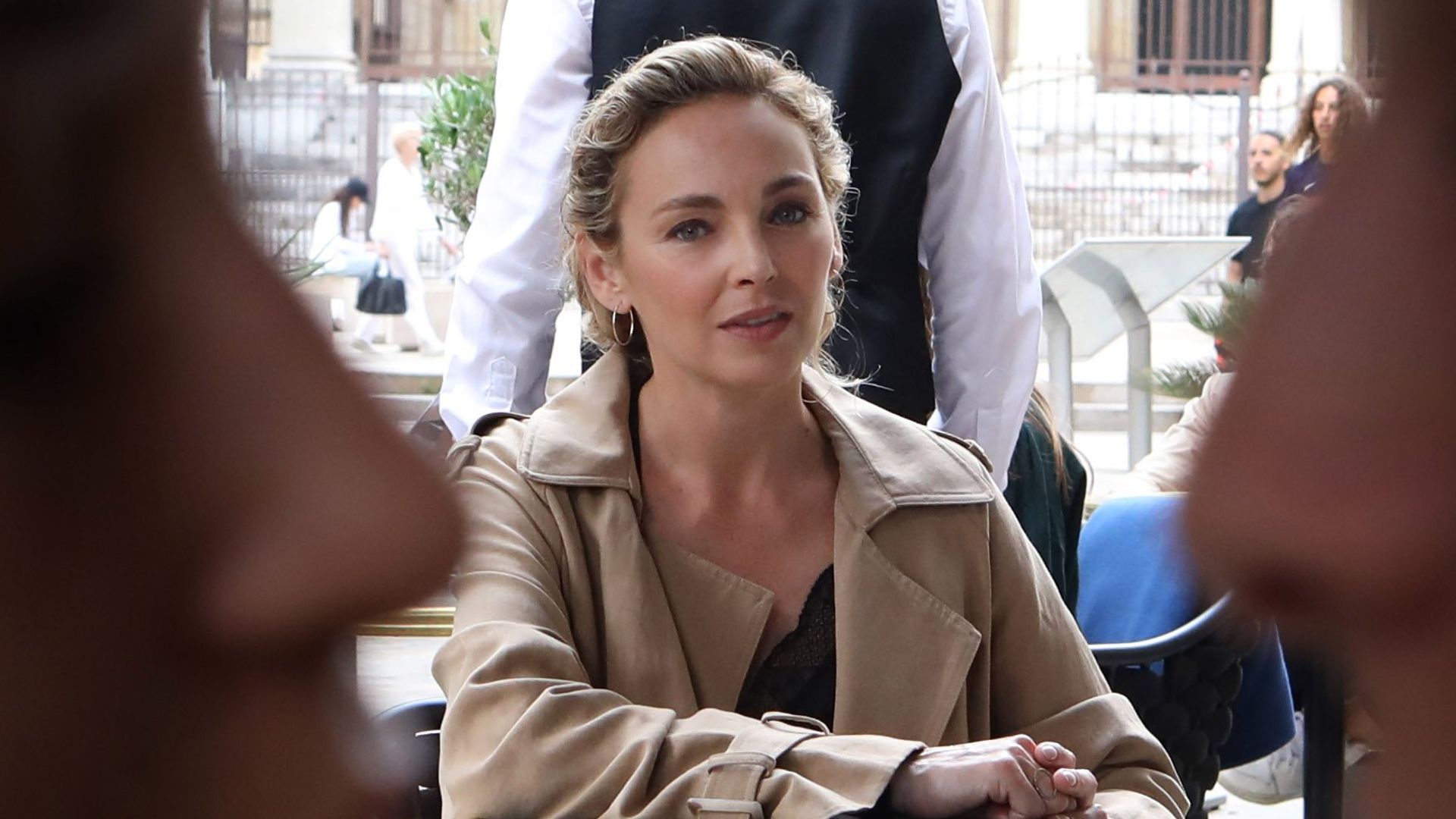 woman at table in busy street