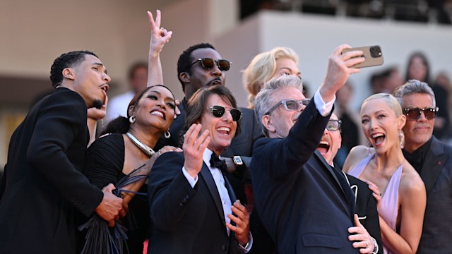 U.S. actor Greg Tarzan Davis, US actress Angela Bassett, US actor and producer Tom Cruise, US actor Tramell Tillman, US film director, screenwriter Christopher McQuarrie, British actor Simon Pegg, British actress Hannah Waddingham, French actress Pom Klementieff, US actor Esai Morales take a group selfie on the steps of the red carpet as they arrive for the screening of the film 'Mission: Impossible - The Final Reckoning' at the 78th edition of the Cannes Film Festival in Cannes, France on May 14, 2025