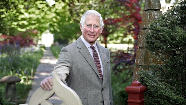 The King posing at the gates of Highgrove House