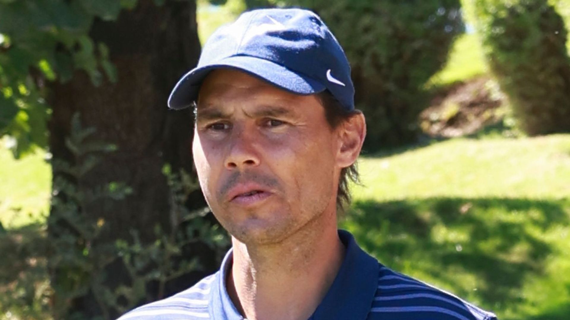 Rafael Nadal with a besmused expression while playing golf