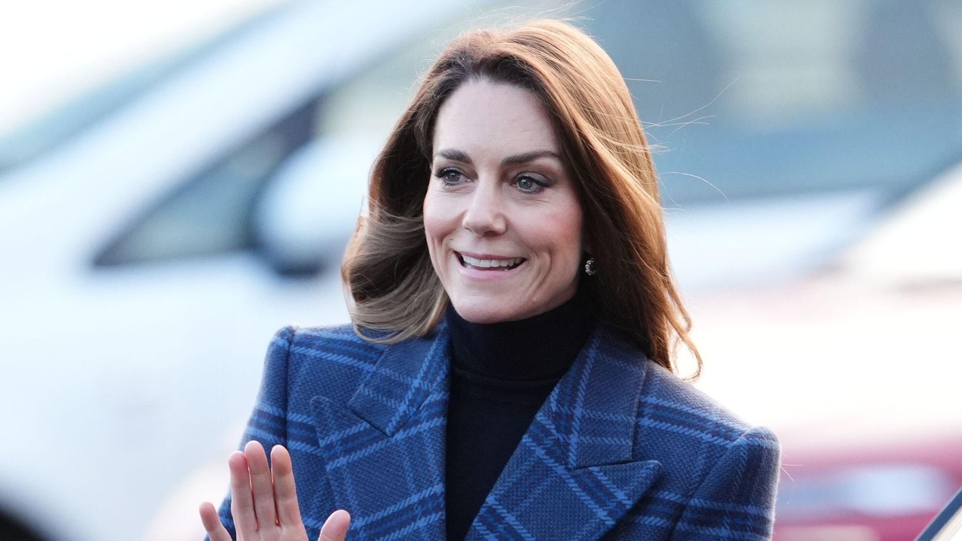 Kate Middleton walking in a tartan overcoat