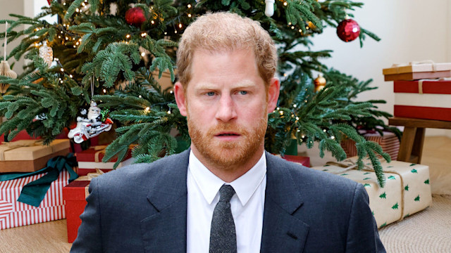 Prince Harry with christmas gift backdrop