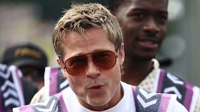 Brad Pitt in racing clothes looking pensive