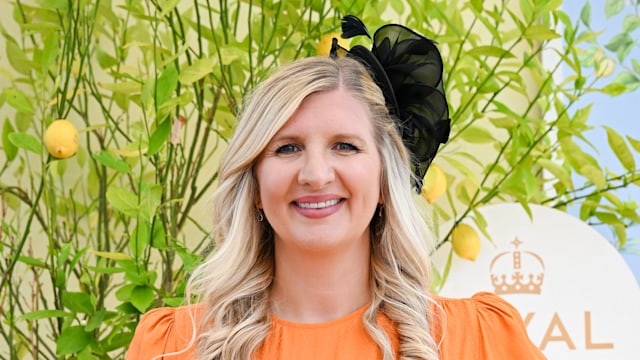 Rebecca Adlington posing in an orange dress