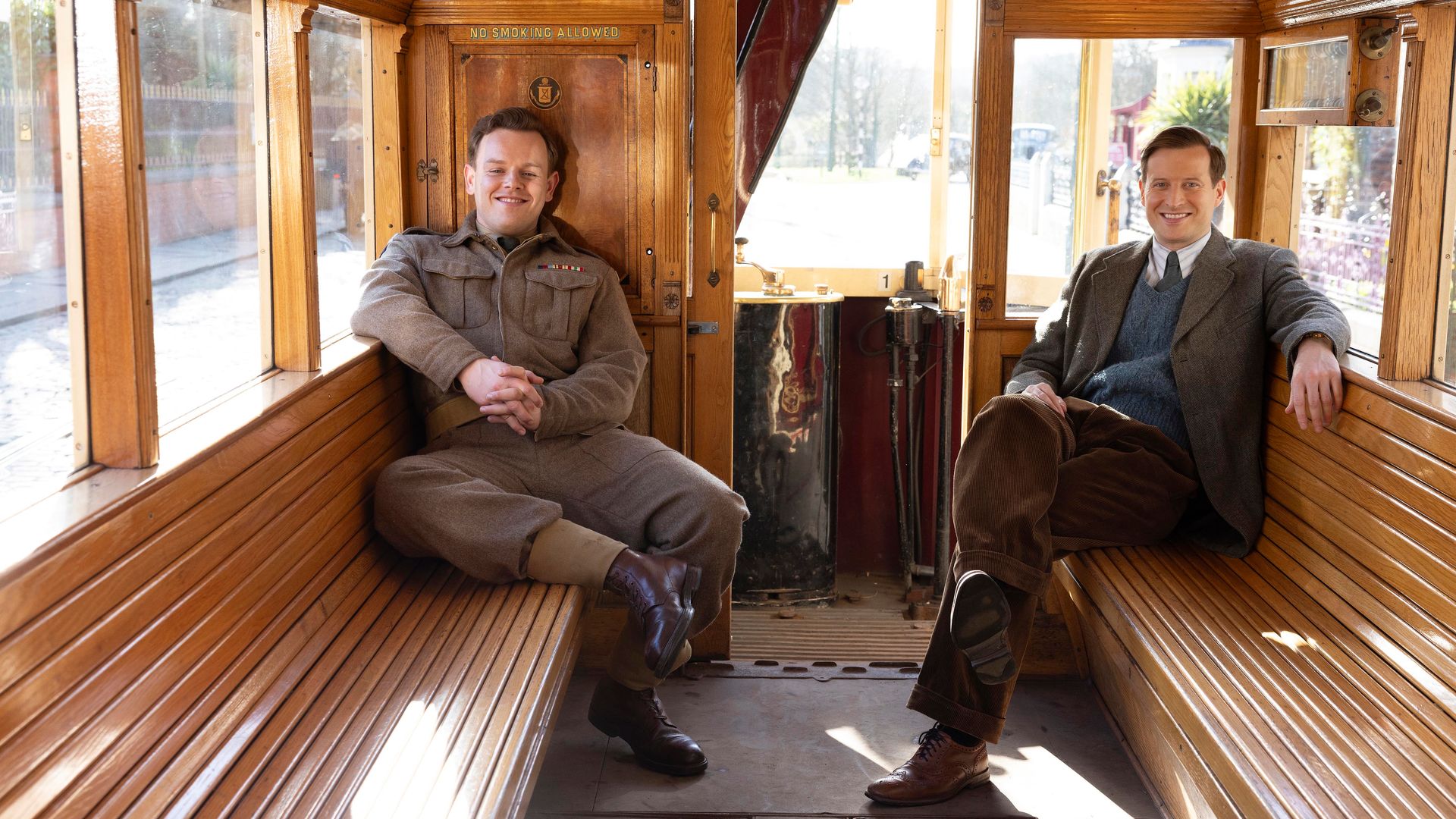 Still image of Callum Woodhouse and Samuel West on a tram from All Creatures Great and Small