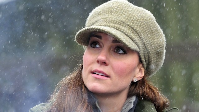 Catherine, Princess of Wales joins in making campfire food during a visit to the Great Tower Scout camp at Newby Bridge in Cumbria on March 22, 2013.   The royal braved snowy conditions to pay a visit to the scout camp.