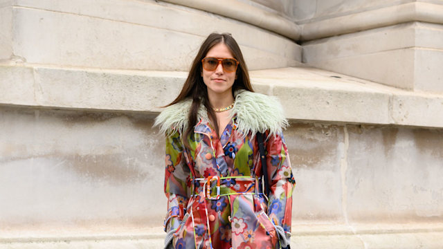 Natalie Salmon wears a Celia B coat, Chie Mihara boots, Me + Em skirt outside the Huishan Zhang show during London Fashion Week 