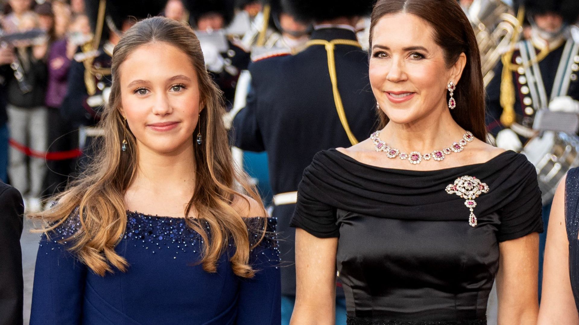 Queen Mary and Princess Josephine smiling on red carpet