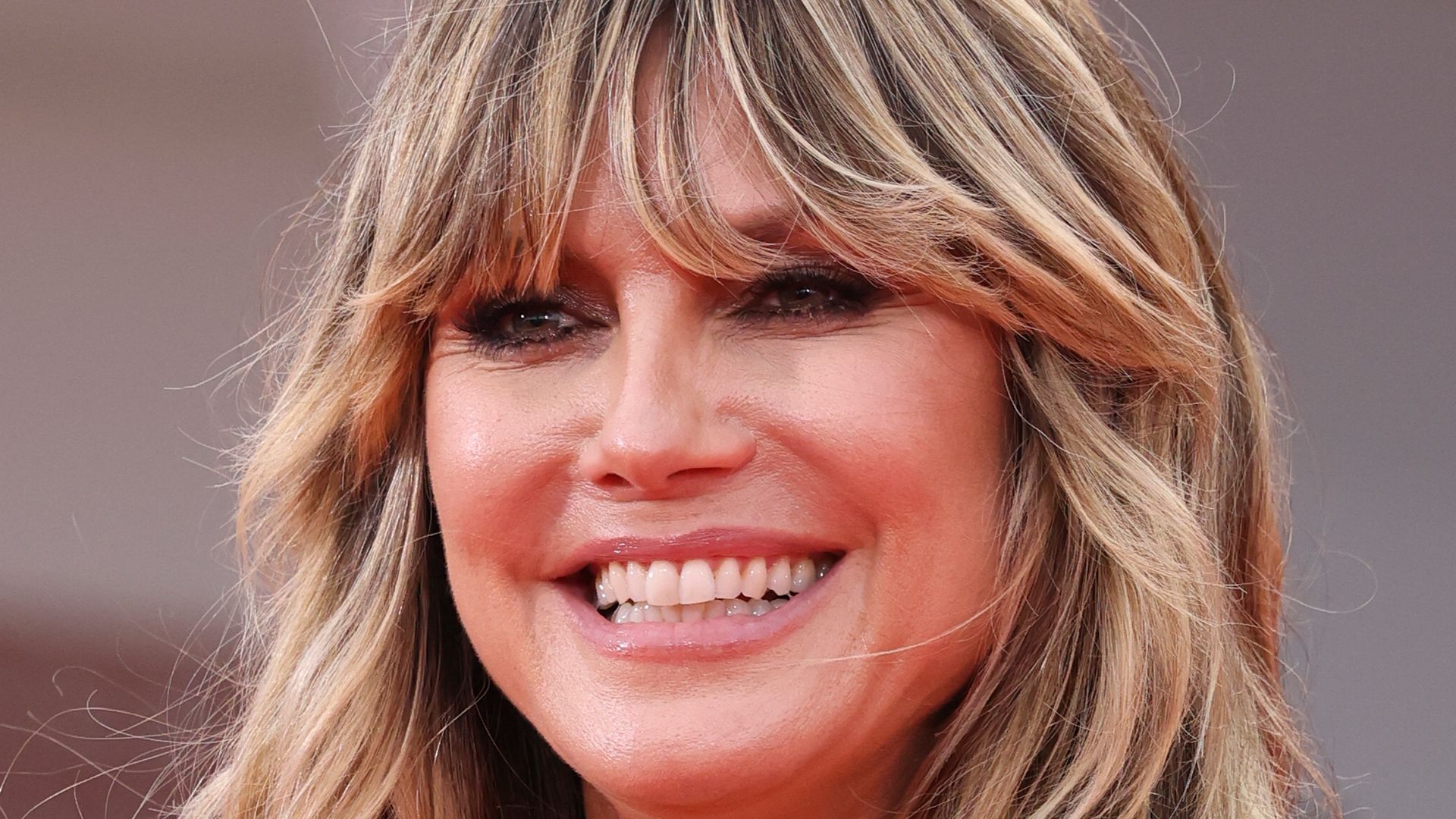 Heidi Klum smiling in soft pink corset