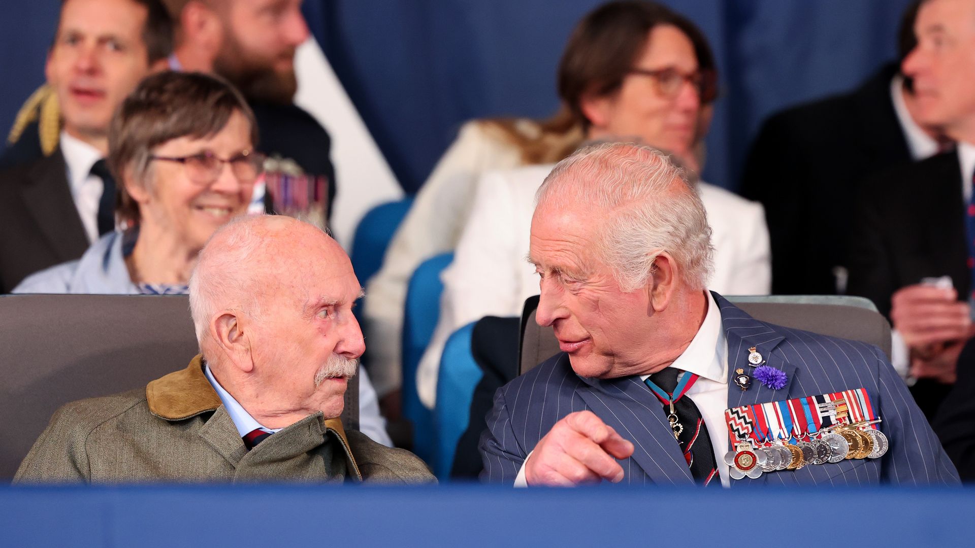 King Charles speaking with an elderly man