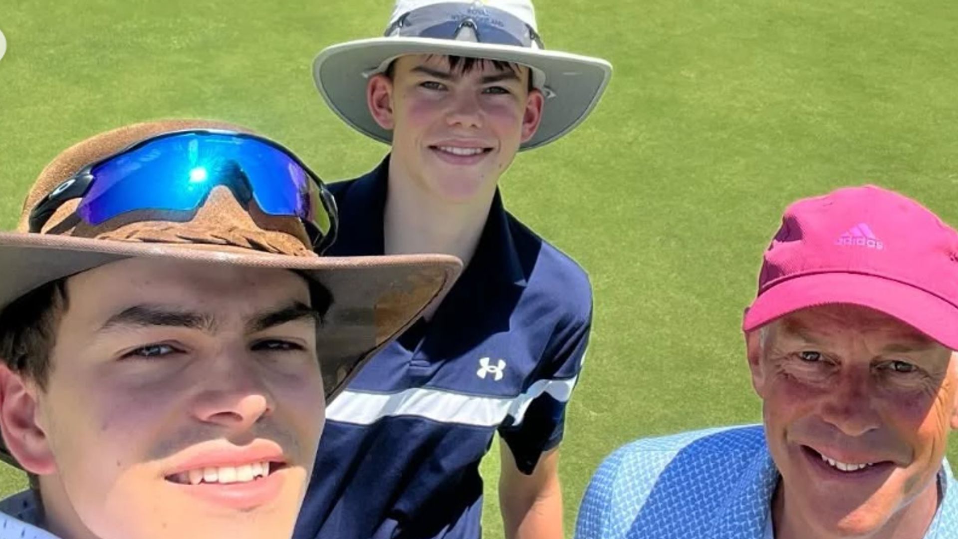 Phil Spencer and his two sons on a golf course