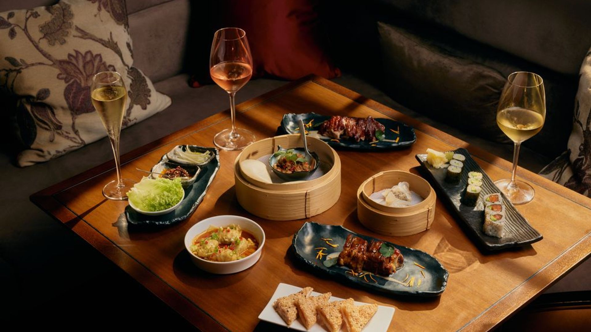 Brunch at Mei Ume featuring a mix of dim sums, sushi rolls and wine glasses