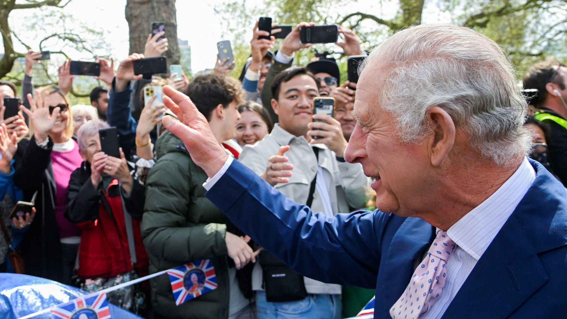 King Charles waving at crowds ahead of the coronation