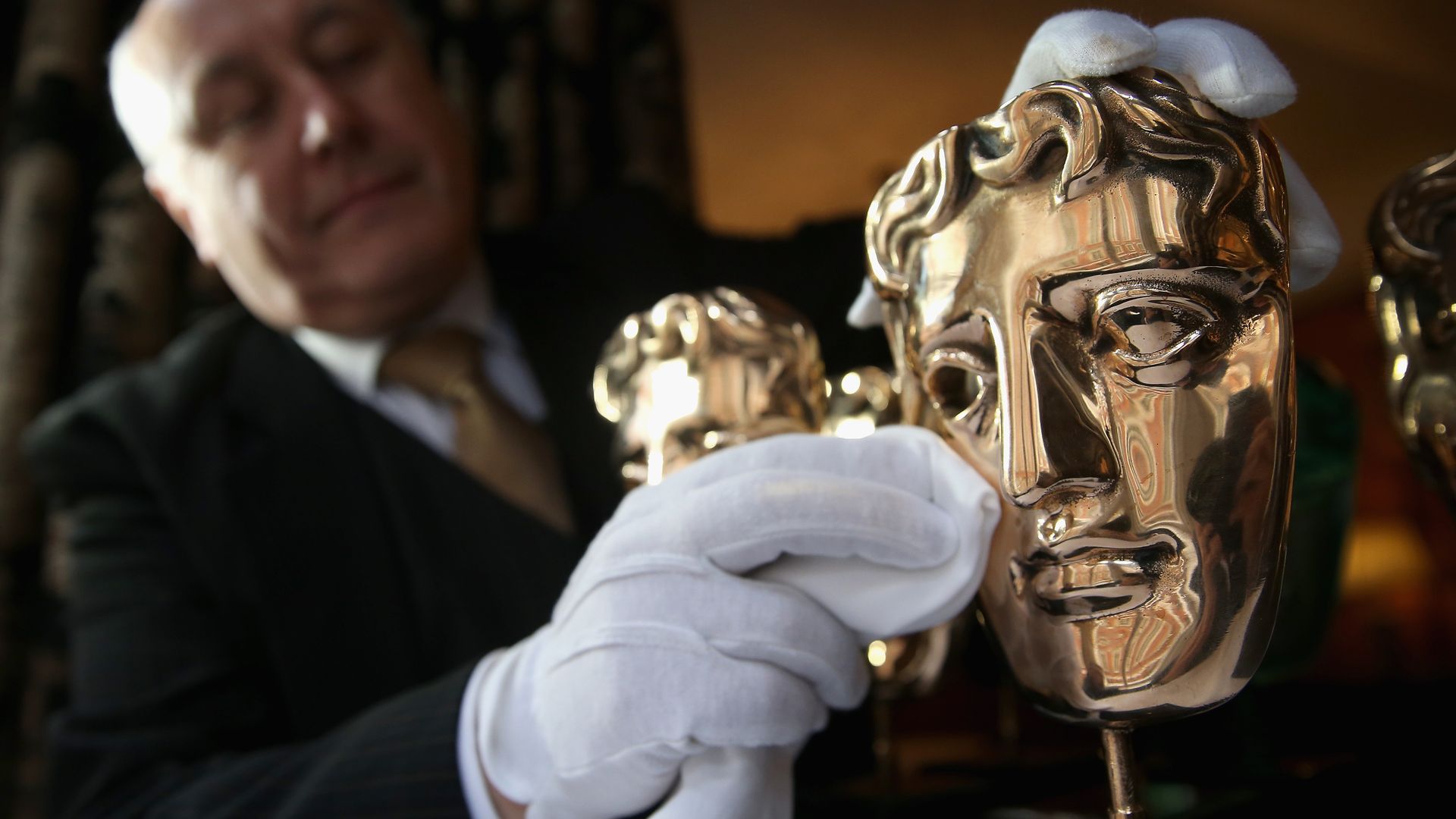 The iconic BAFTA mask awards are polished by a butler at the Savoy Hotel ahead of the British Academy Film Awards 