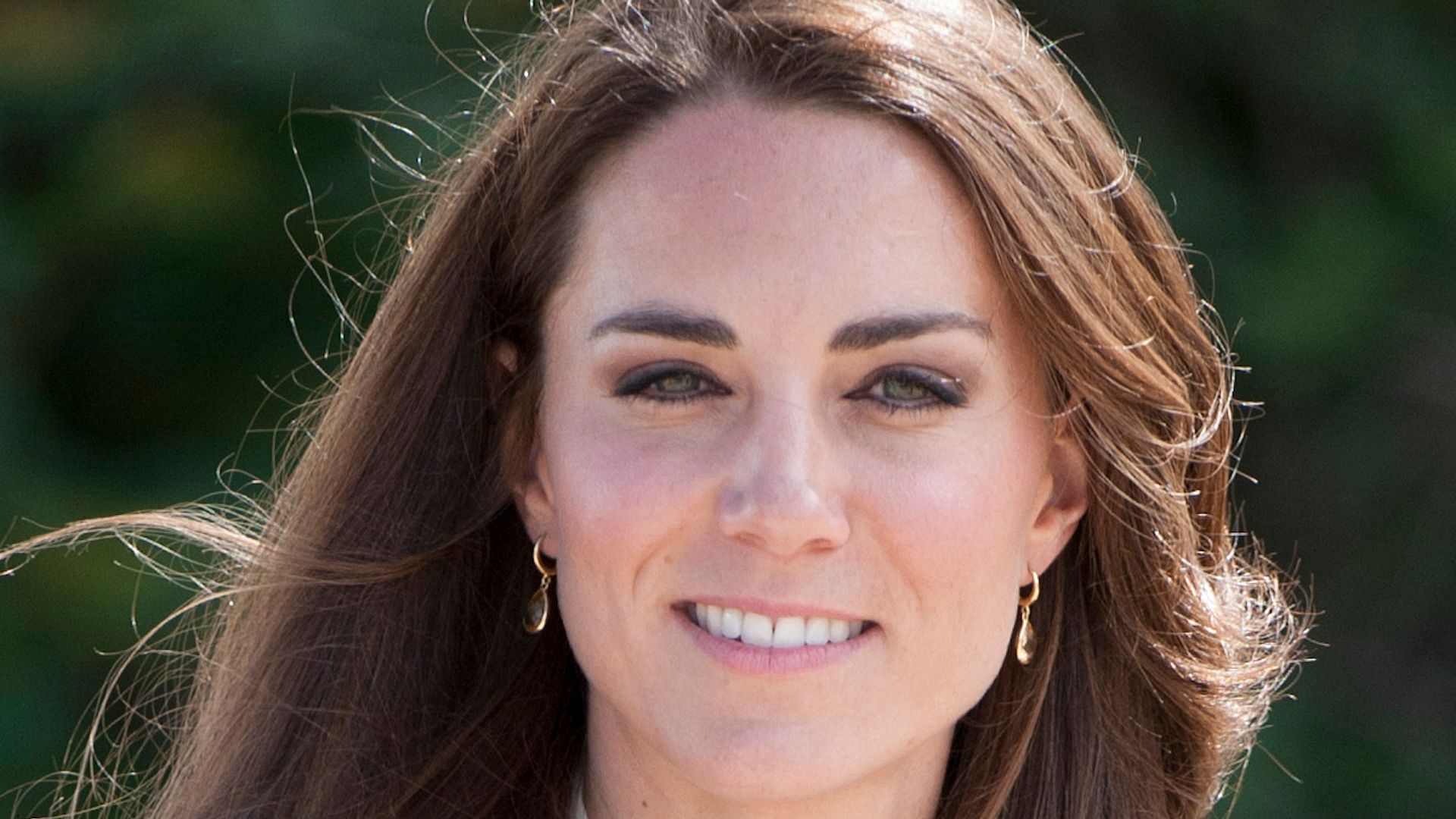 Catherine in navy suit and white ruffle blouse