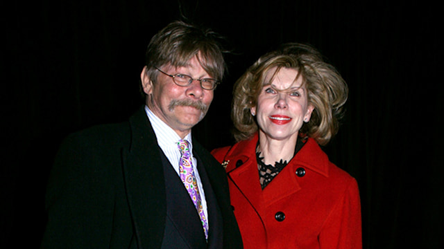 Christine Baranski wearing a red coat. She is pictured with her late husband Matthew Cowles, who is wearing a black jacket and grey trousers. 