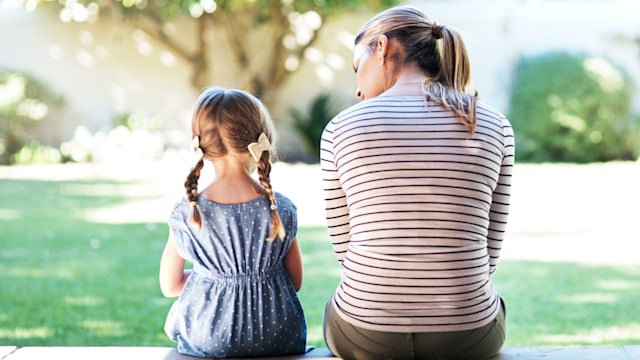 mother talking to child on porch