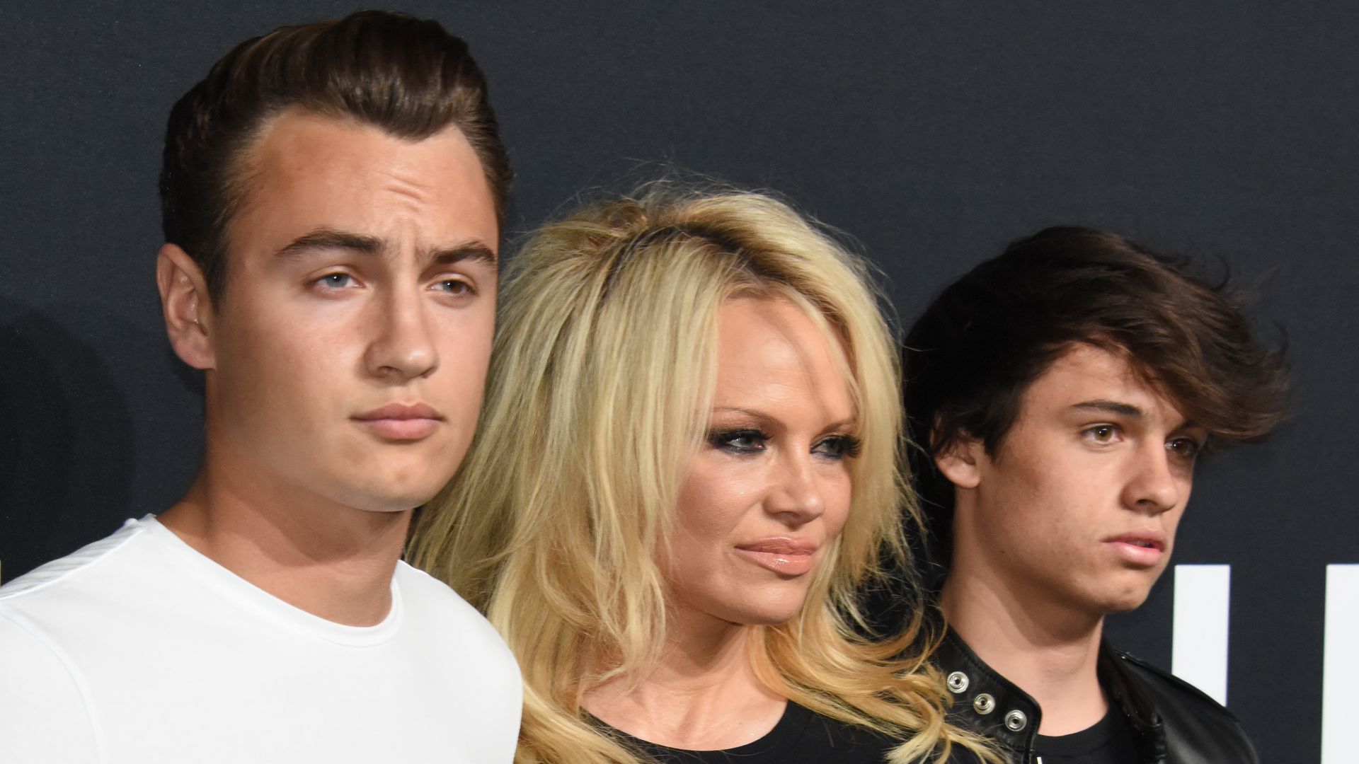 Brandon Thomas standing with Pamela Anderson and Dylan Jagger