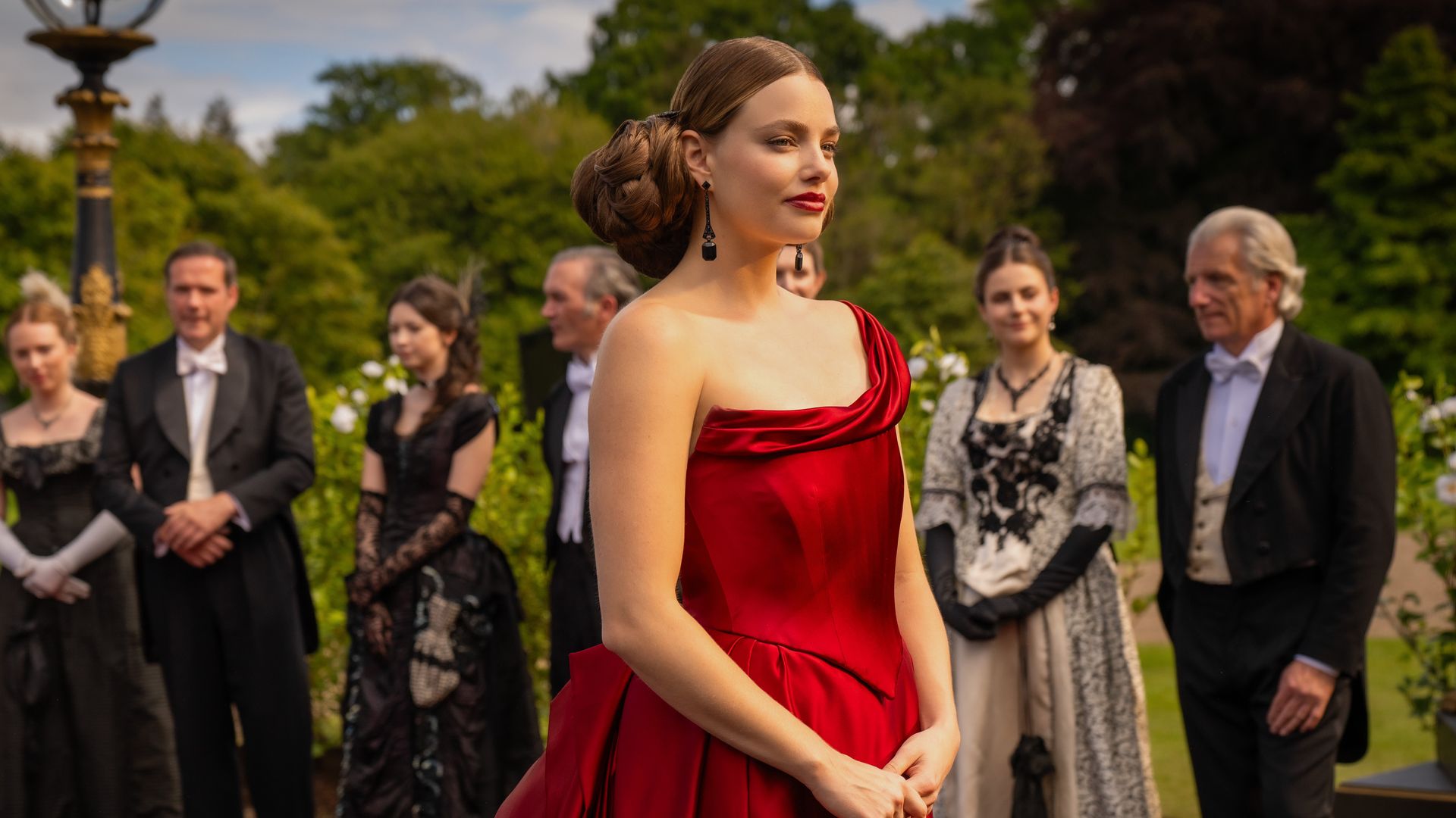 young woman in bold red dress at party