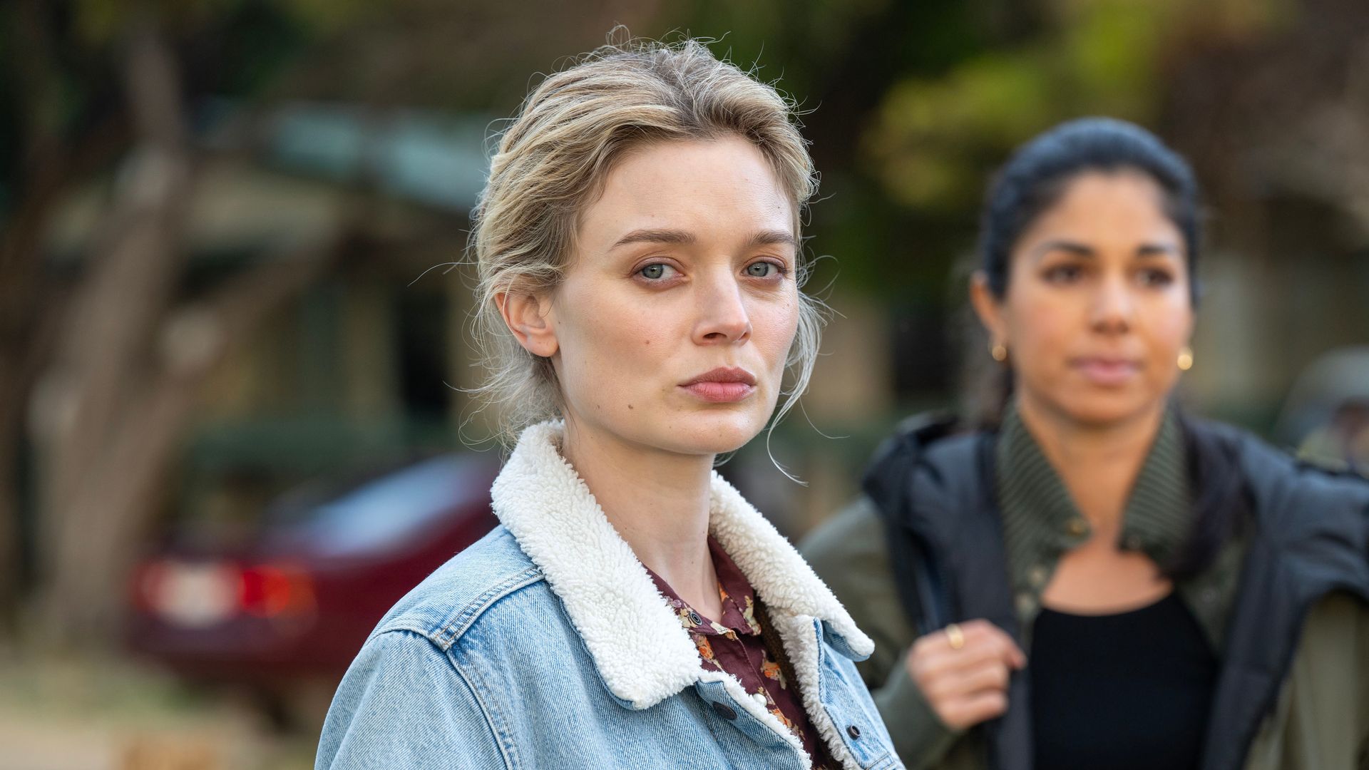 blonde woman in blue jacket close-up