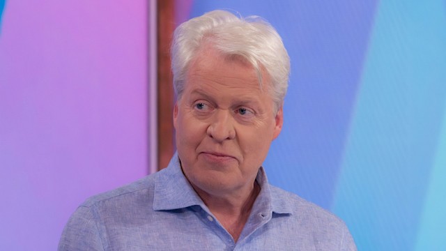 Earl Spencer in blue shirt with lilac backdrop