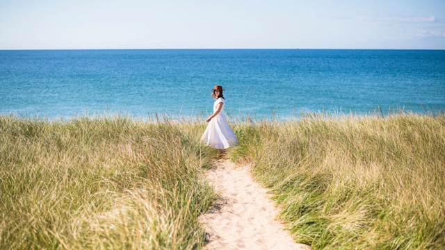 Woman walks on beach