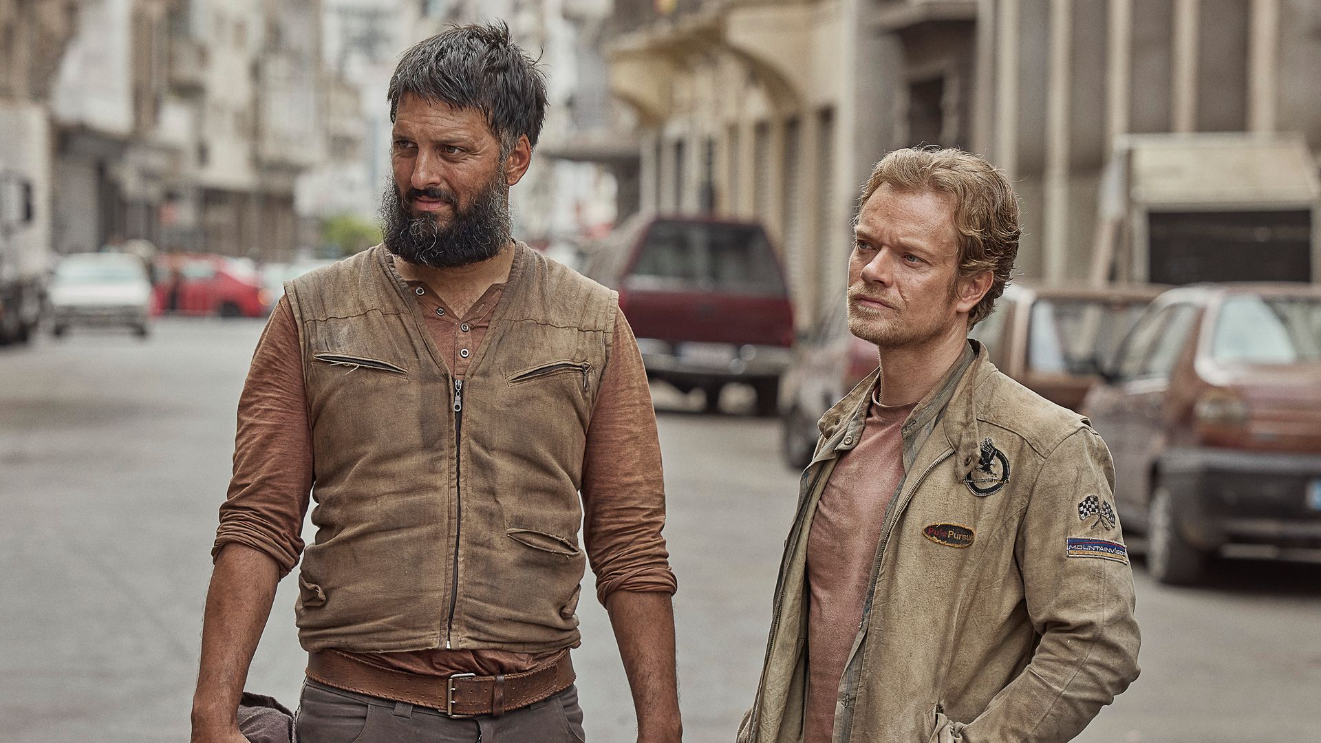 two men standing city street