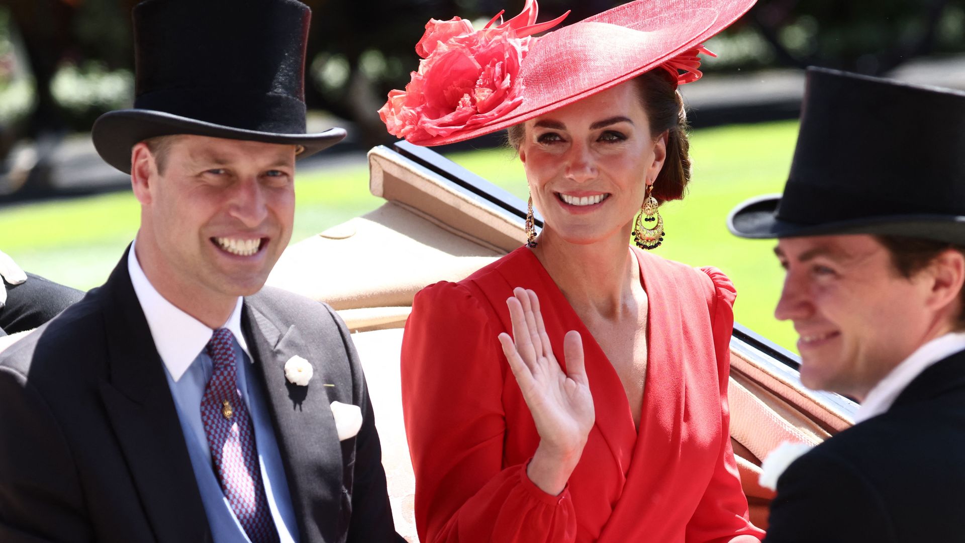 Britain's Prince and Princess of Wales smile as they arrive in a horse-drawn carriage