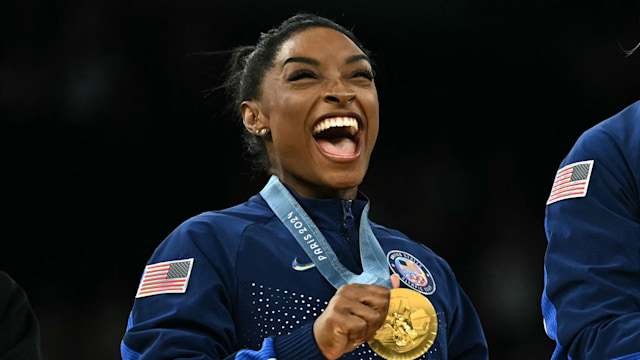 US' Simone Biles poses with the gold medal during the podium ceremony for the artistic gymnastics women's team final during the Paris 2024 Olympic Games