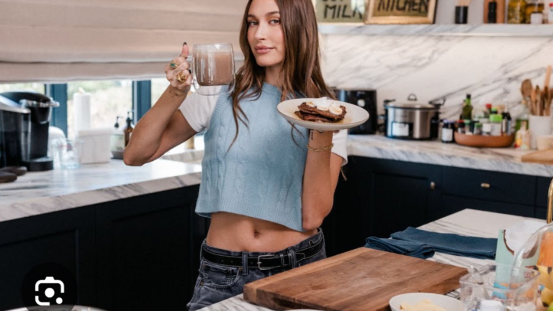 Hailey in her black and marble kitchen 