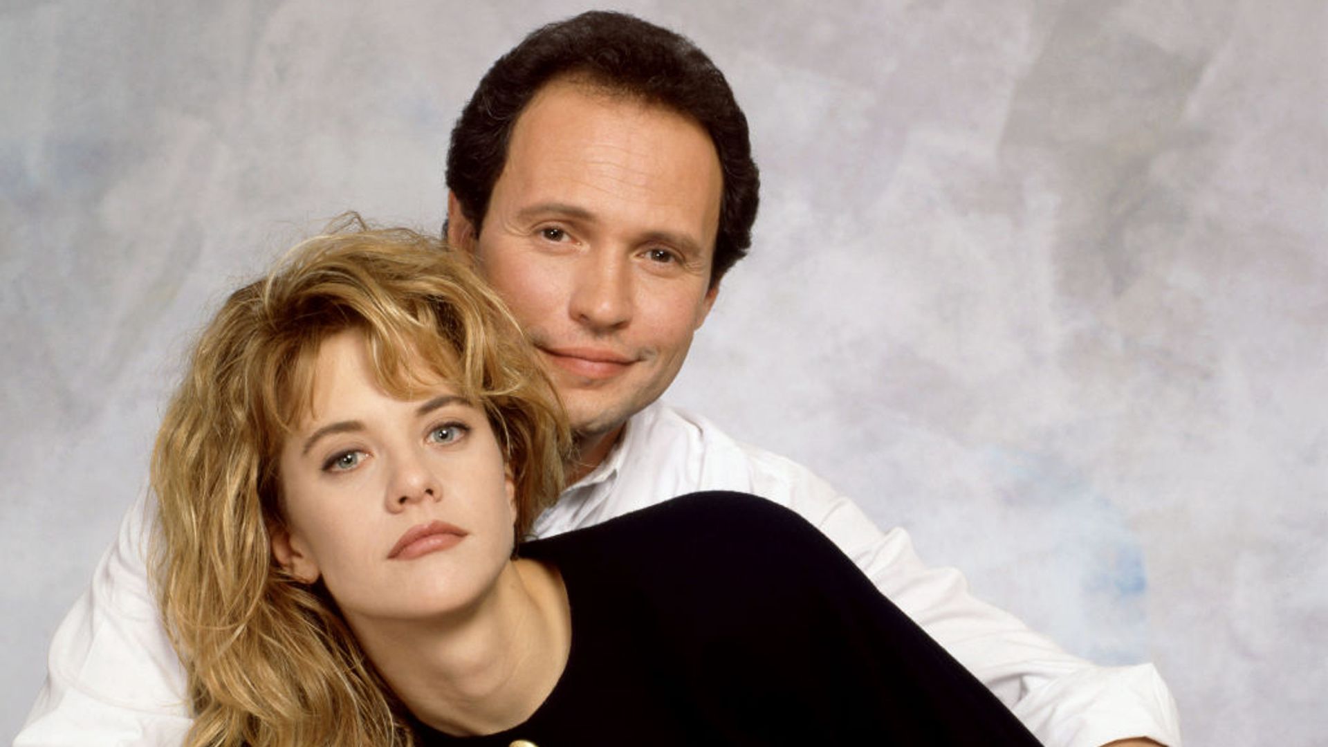 Meg Ryan cuddled up to Billy Crystal in a promotional photo for When Harry Met Sally