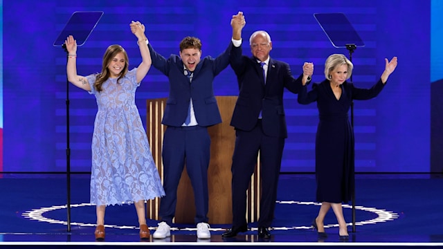 Democratic vice presidential nominee Minnesota Gov. Tim Walz celebrates with his daughter Hope Walz (L), son Gus Walz (2nd-L) and wife Gwen Walz (R) 