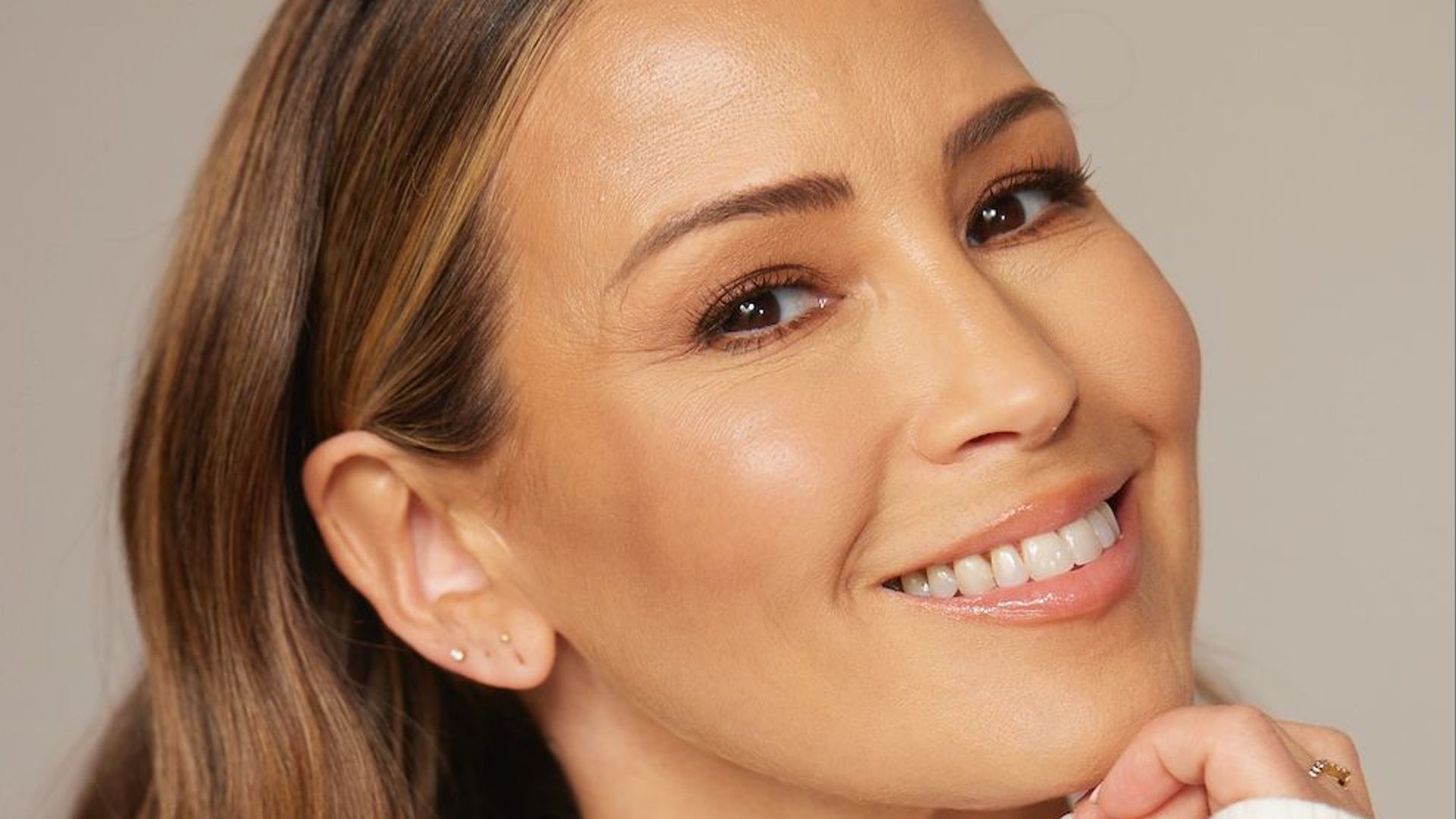 Rachel Stevens smiling in a white long sleeved top 