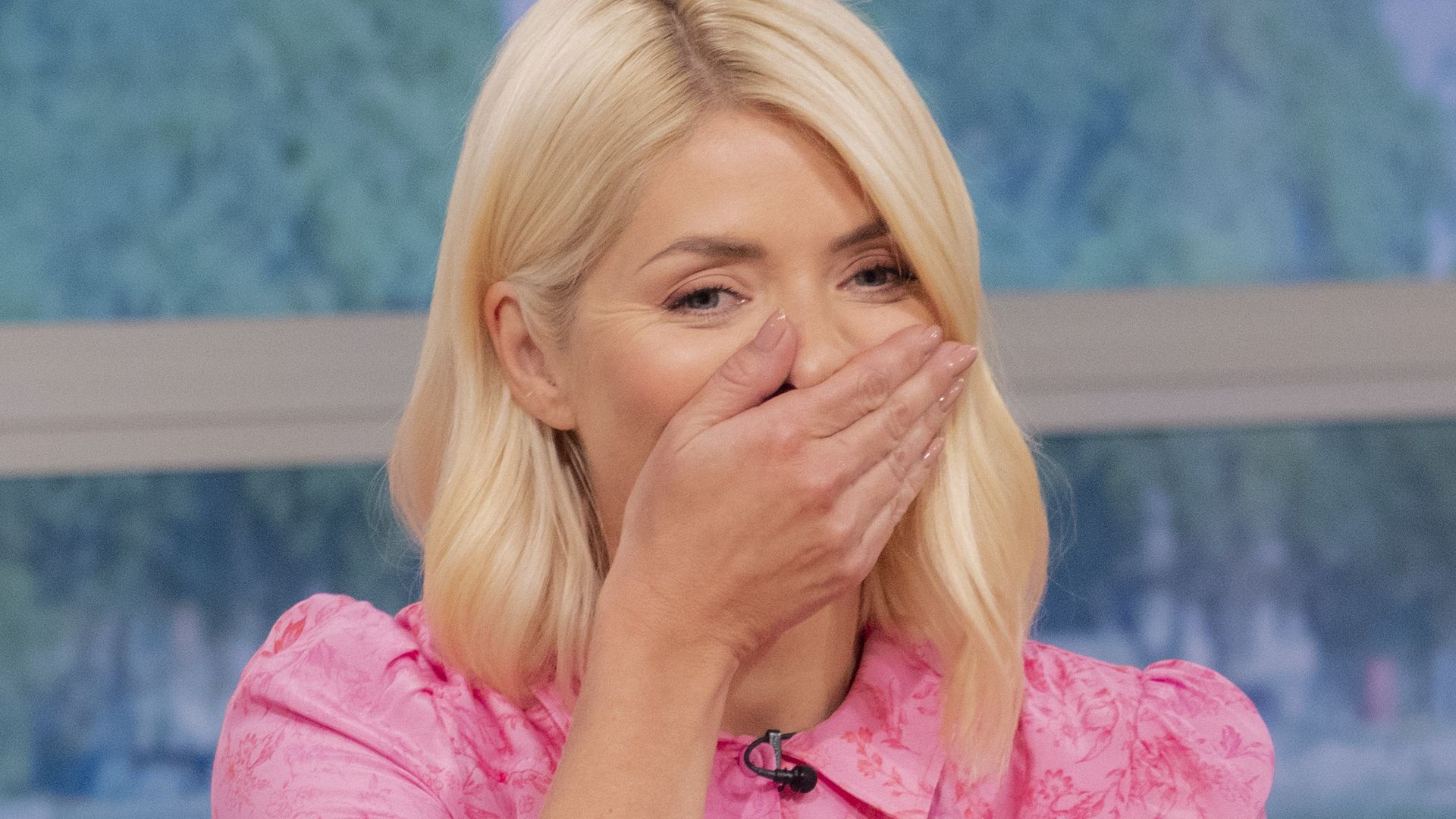 Holly Willoughby holding her hand to her face