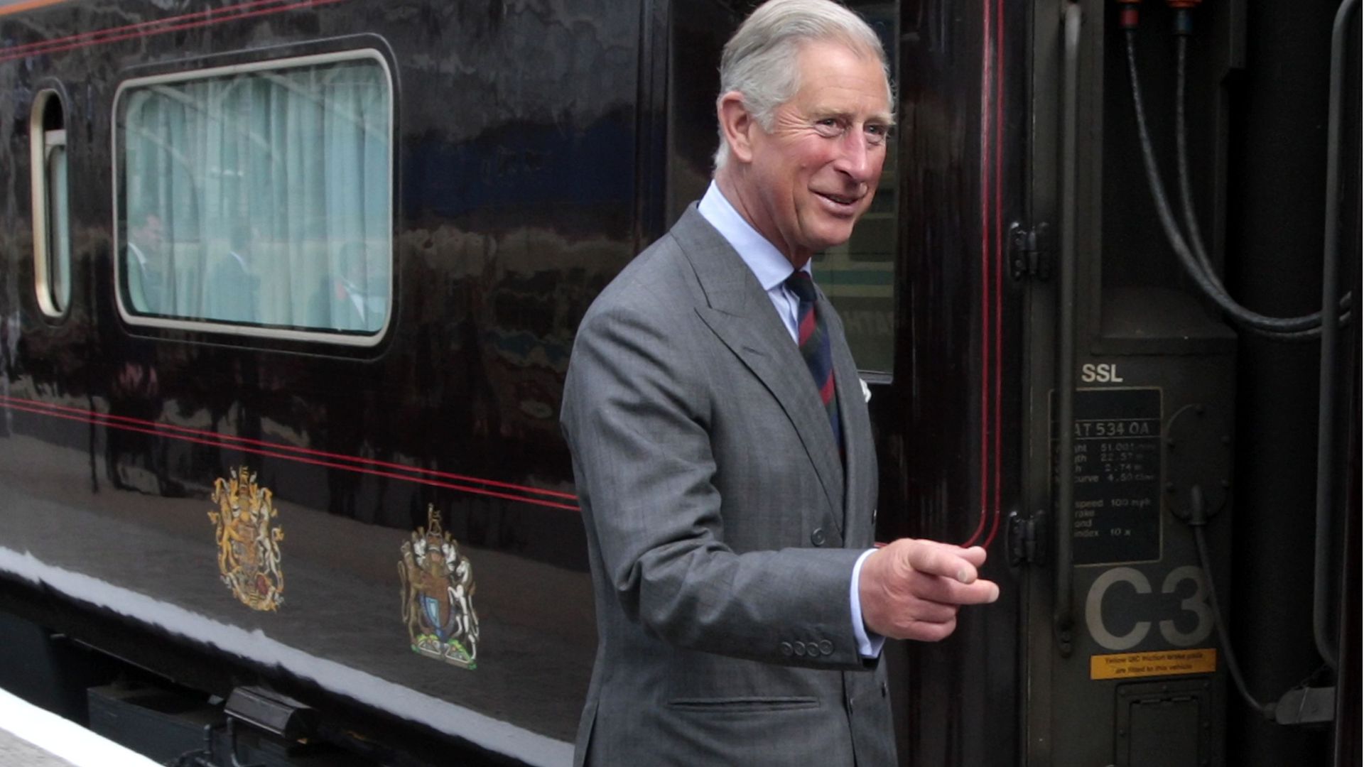 King Charles pointing outside the royal train