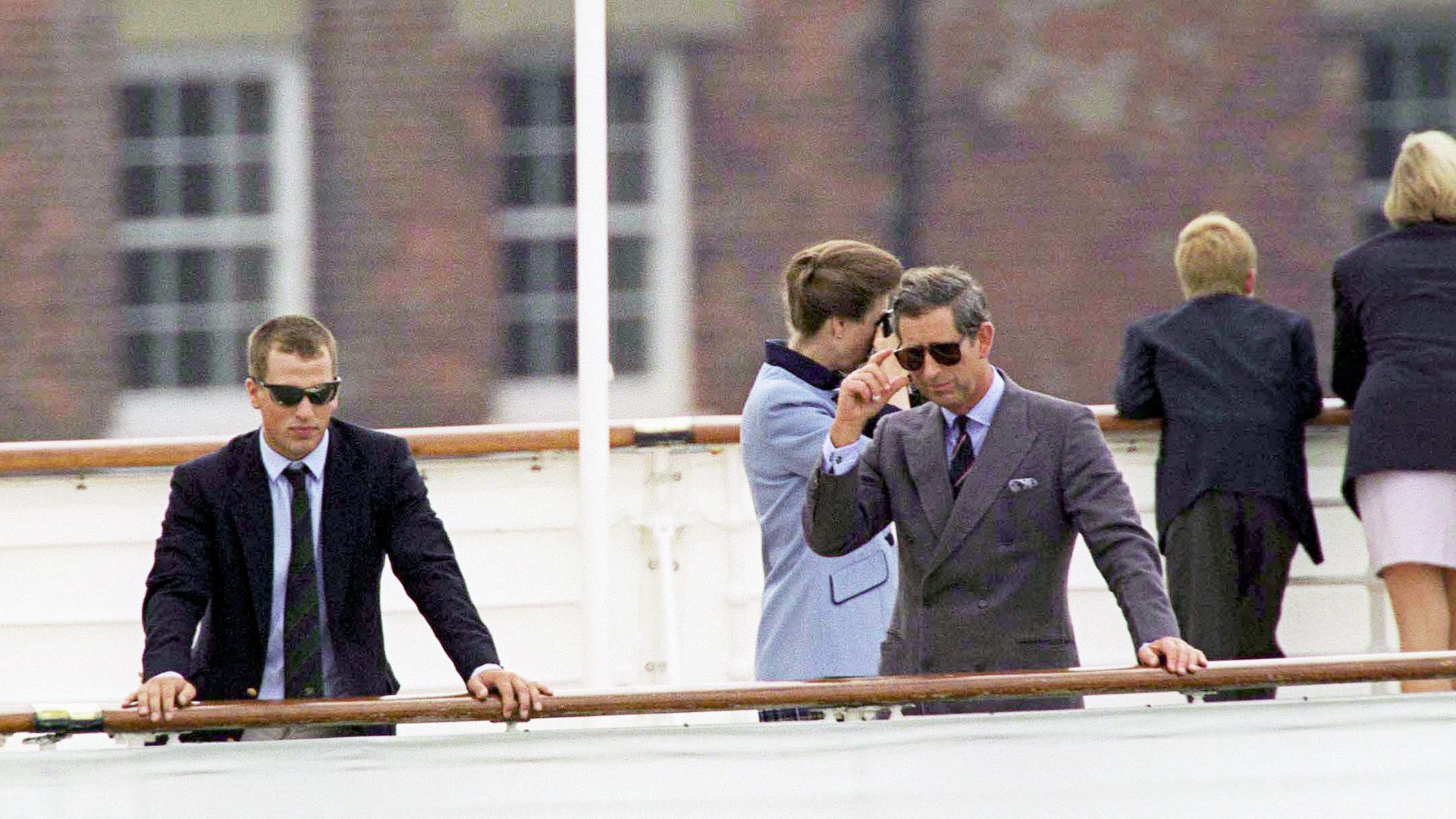 Peter Phillips and Prince Charles wearing sunglasses and suits on board the Royal Yacht Britannia 2007
