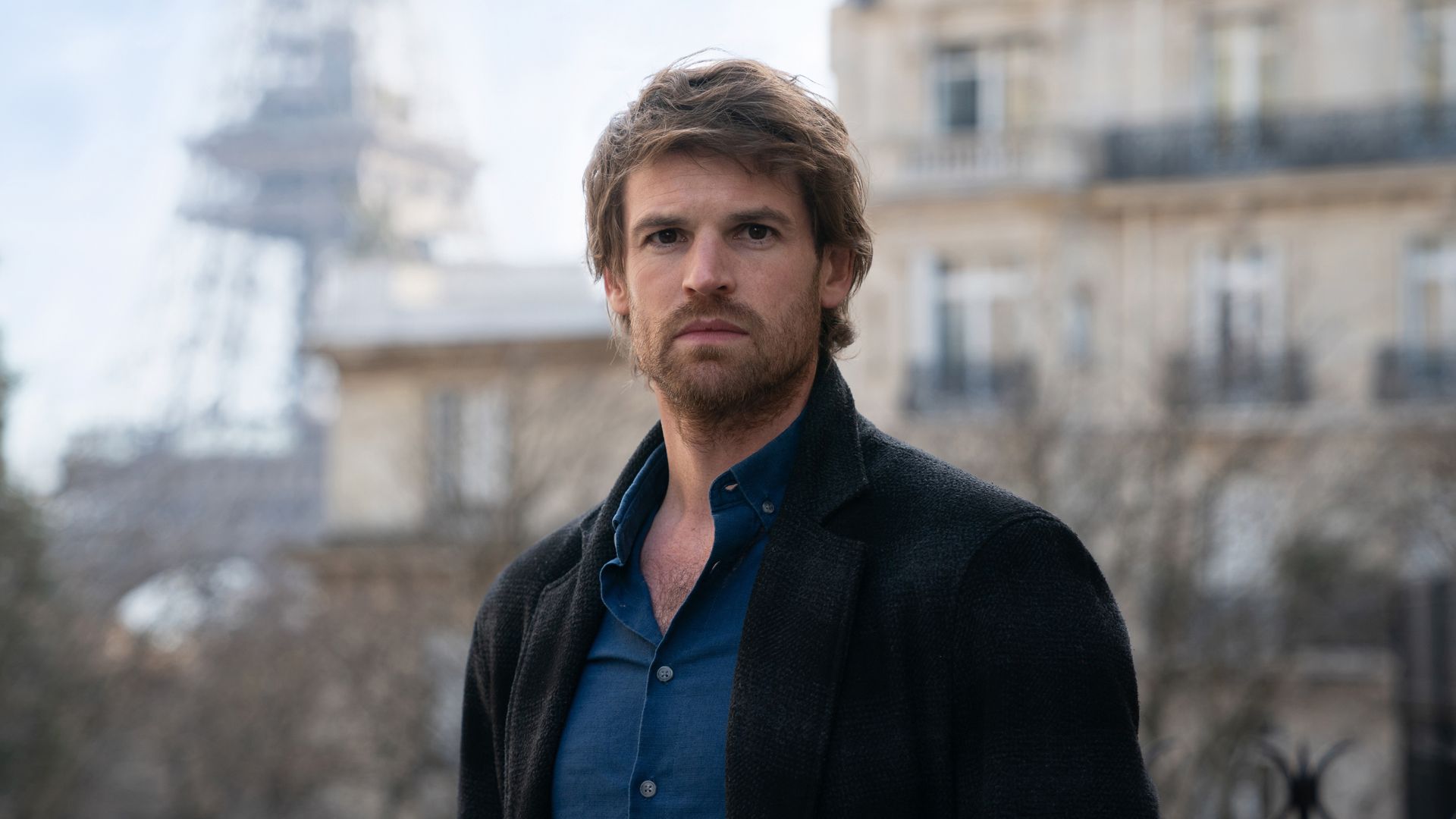 man standing in front of eiffel tower
