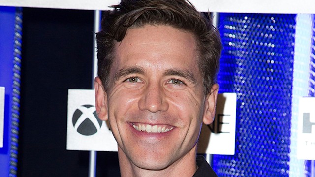 Brian Dietzen smiling. He is wearing a black shirt. 