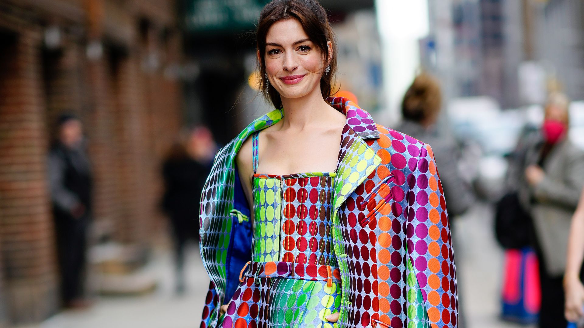 Anne Hathaway is seen outside the Stephen Colbert Show in a rainbow spotted outfit