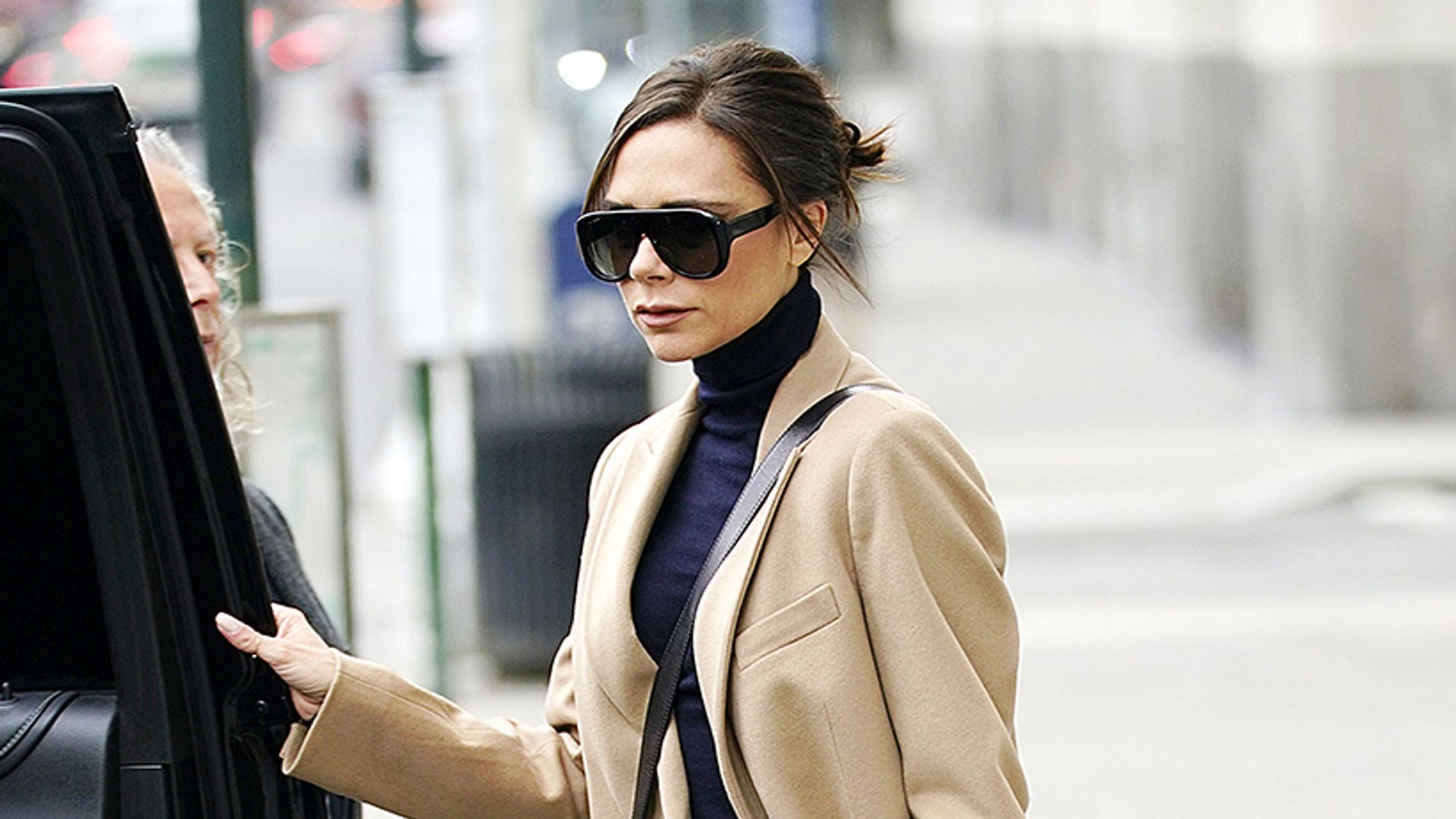 Victoria Beckham wears navy roll neck, navy boots and yellow pleated ...