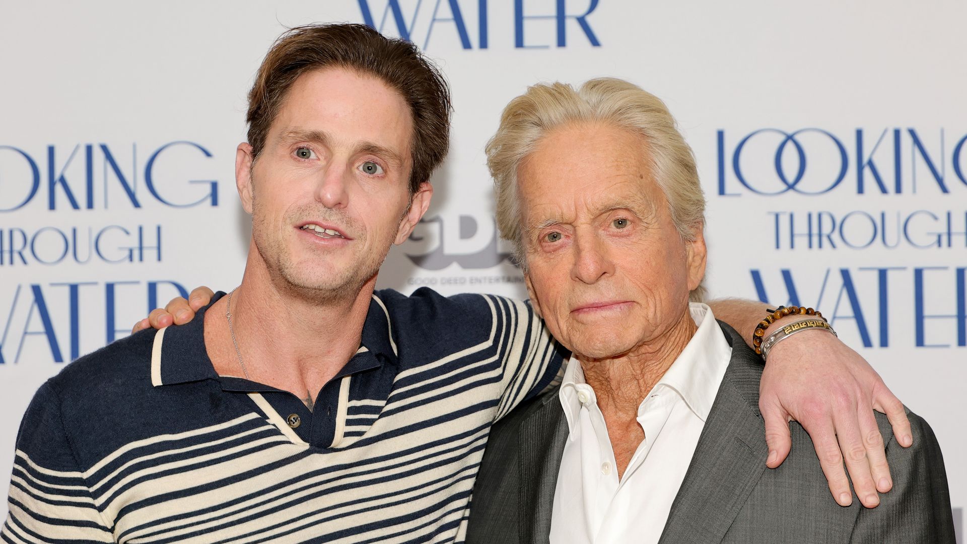 Michael Douglas' son Cameron lifts shirt to reveal tattooed faces of dad and famous grandfather Kirk — watch