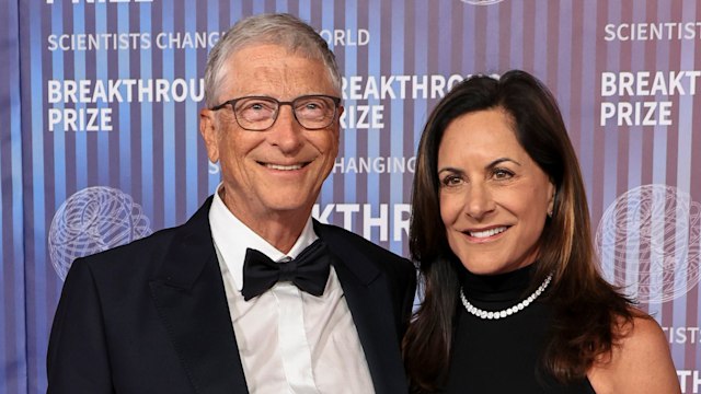 Bill Gates in a black tuxedo and Paula Hurd in a black dress