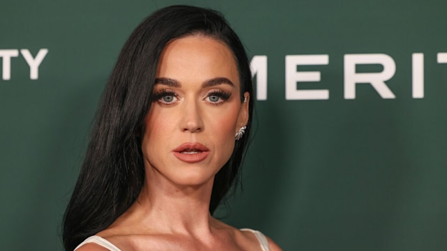 Katy Perry looking directly into the camera in a strappy dress