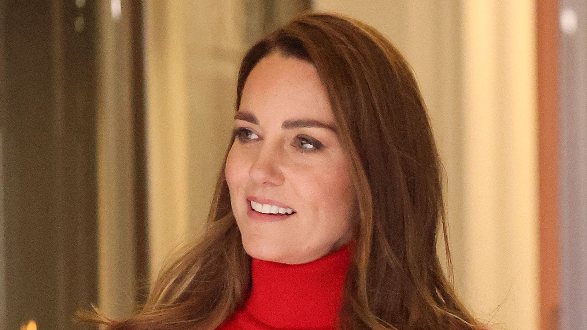 Catherine in red rollneck and skirt