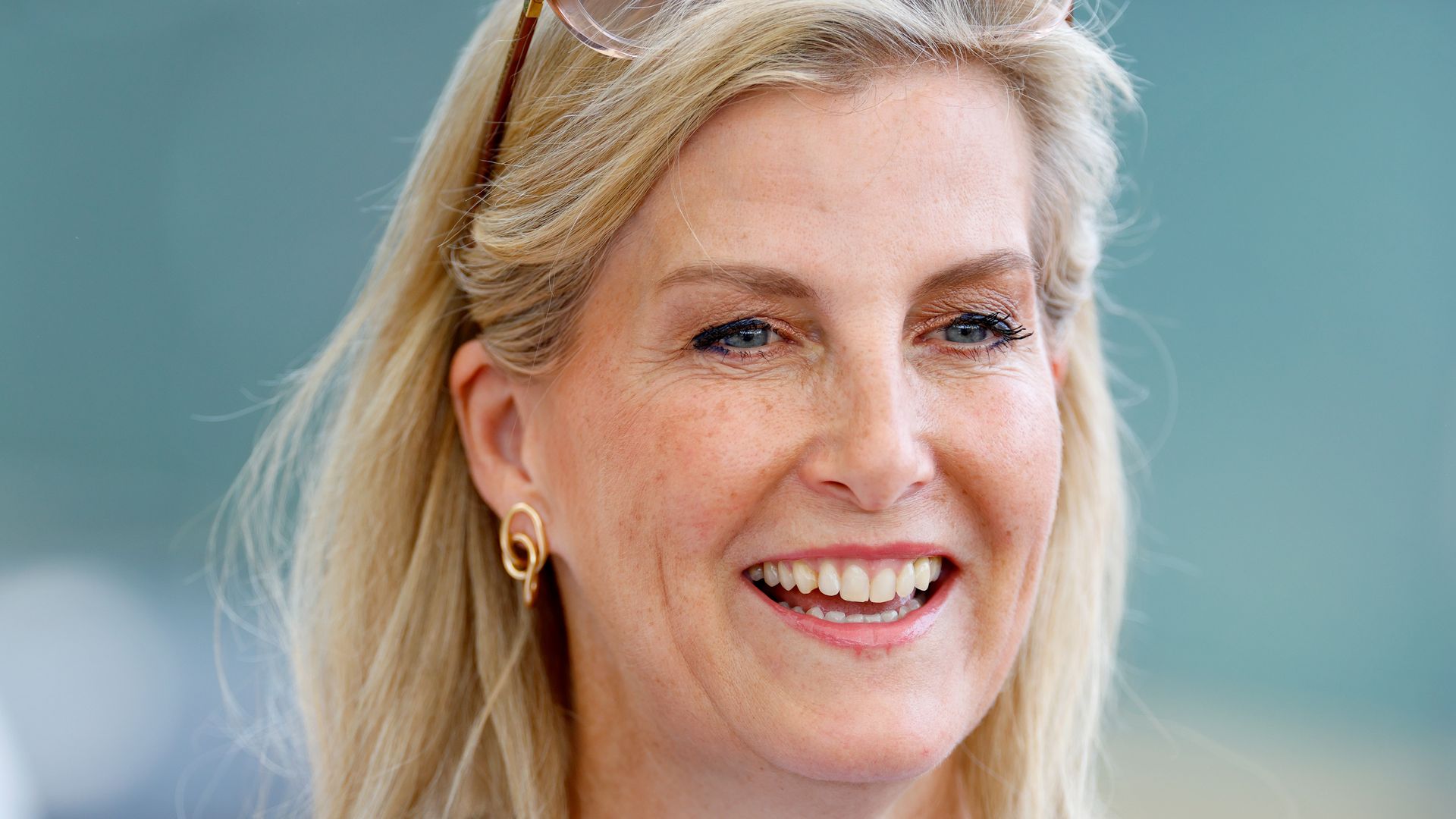 Sophie, Duchess of Edinburgh grinning in blue printed dress